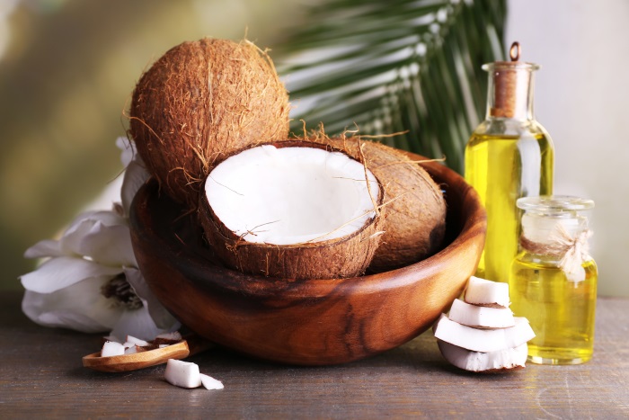 Coconuts and coconut oil on wooden table