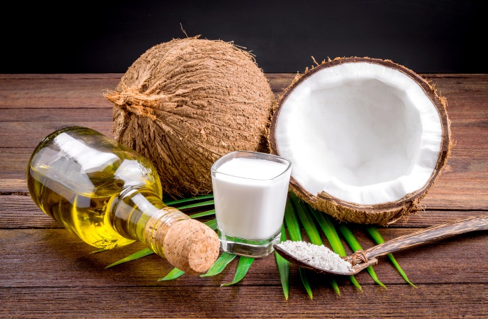 Coconut milk and coconut oil on wooden table