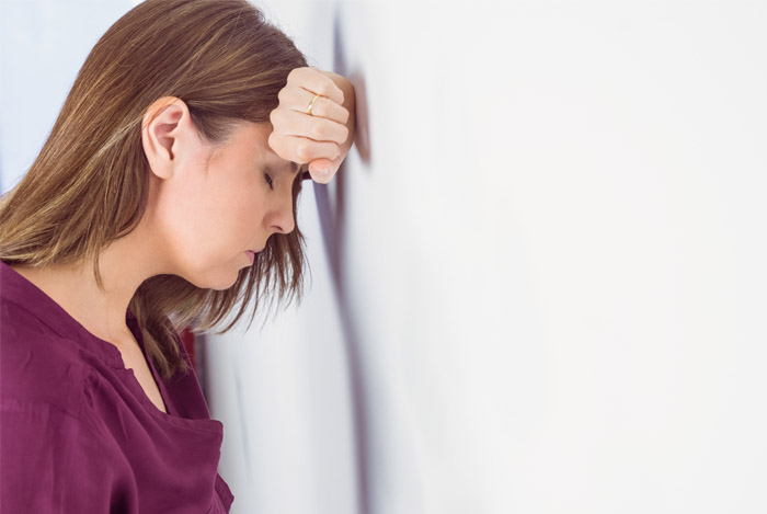 depressed-woman-by-a-wall