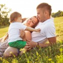 Family with one baby playing in the park