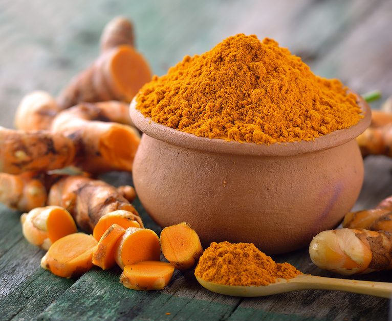 turmeric roots in the basket on wooden table