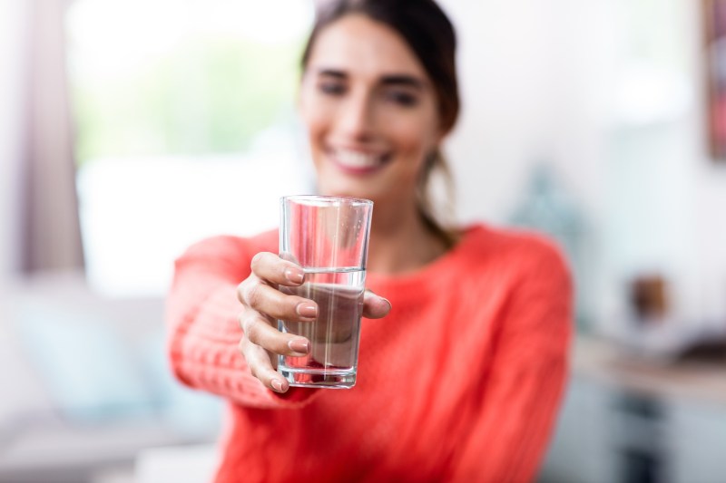woman holding a glass of water